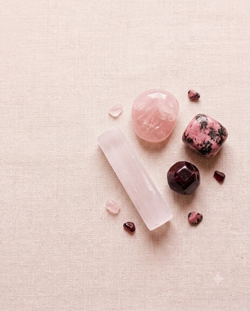 Rose quartz, rhodonite and garnet in warm blush light